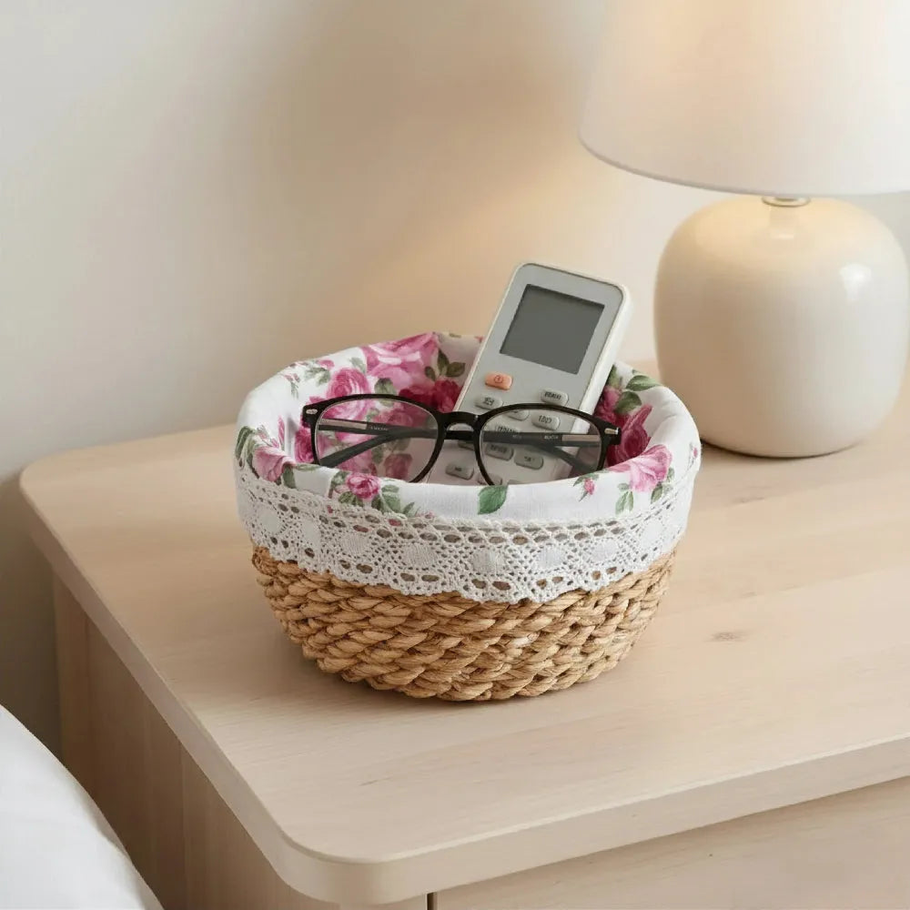 Woven basket with floral fabric on a nightstand next to a lamp