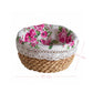 Woven basket with floral lid on a white background