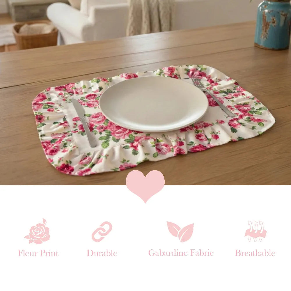Fleur print ruffled placemat with a white dinner plate, fork, and knife on a wooden dining table.