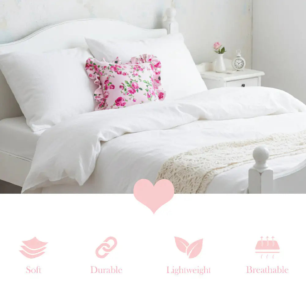 Fleur Ruffled Square Cushion with Filling pale pink on bed with feature icons showing softness durability lightness breathability