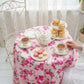 Fleur Table Cover used in tea party setup with tea set, pastries, and cookies on floral tablecloth