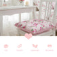 Floral chair cushion in a bright room with a prominent heart symbol overlay on the image.