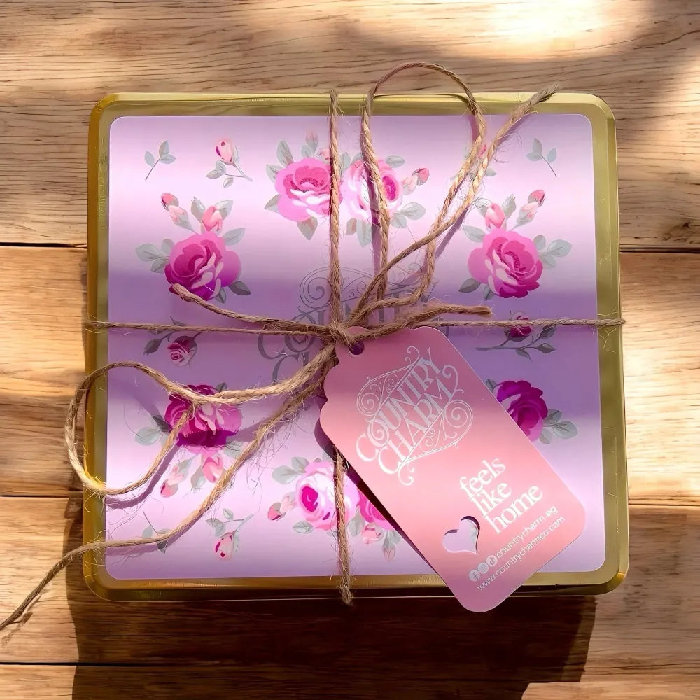 Gift box with floral design and pink tag on a wooden surface