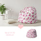 Floral-patterned bean bag chair in a room with a plant and small table.