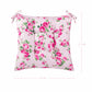 Floral-patterned cushion with pink roses on a white background