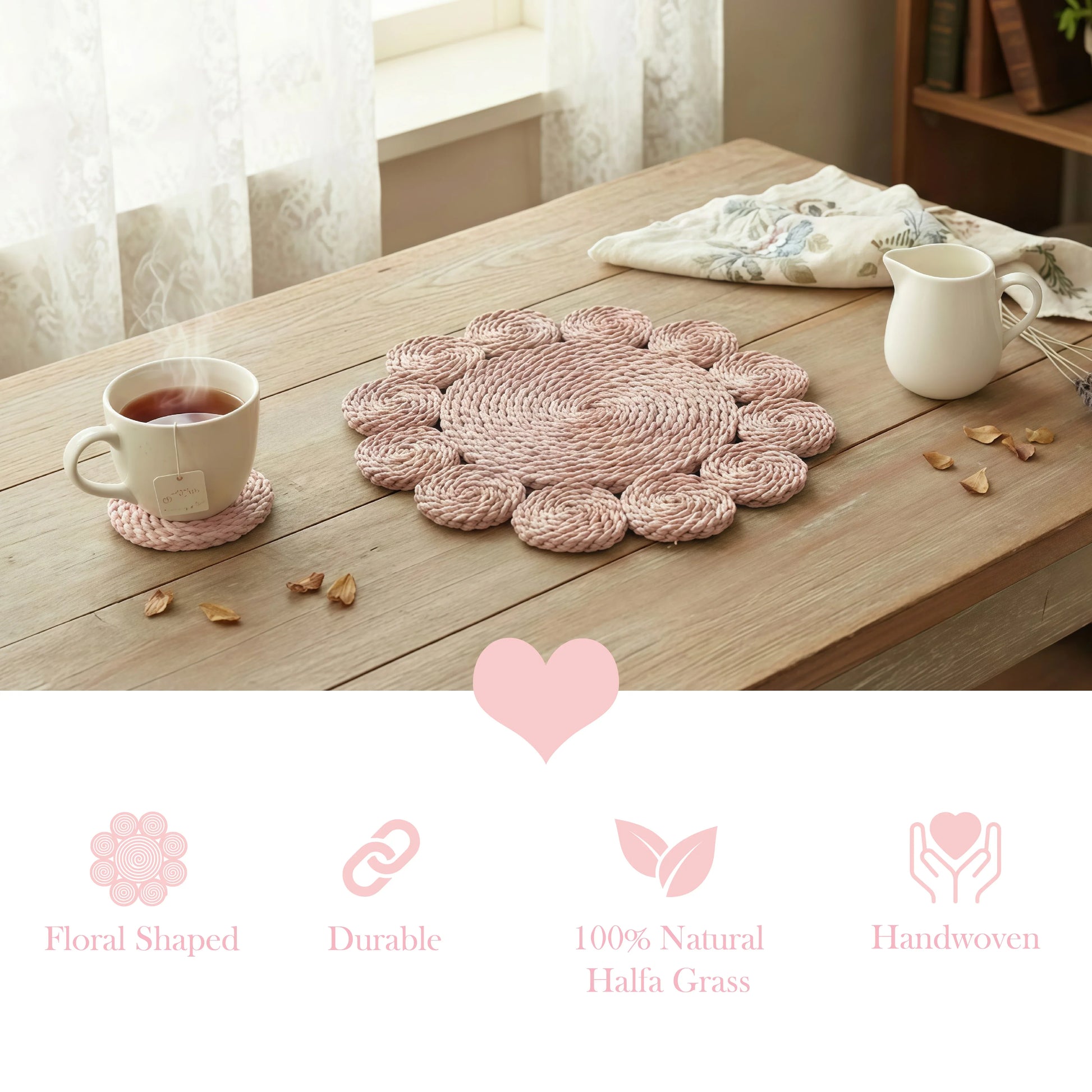 Pink floral woven placemat and matching coaster with a teacup on a light wood table near a bright window.