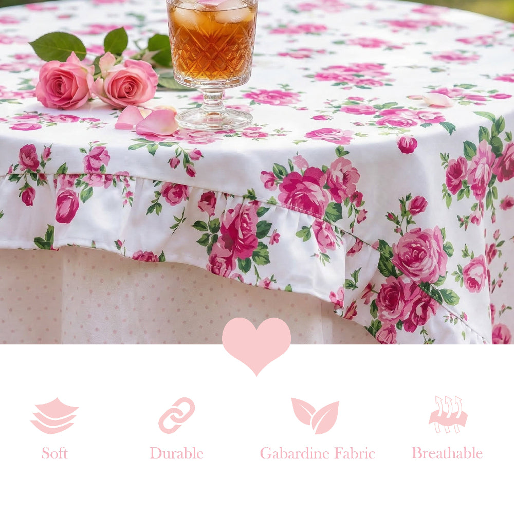 Floral tablecloth with pink roses on a table setting with a glass of tea.