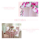Floral tablecloth with polka dots and ruffles, shown on a table in a dining room setting.