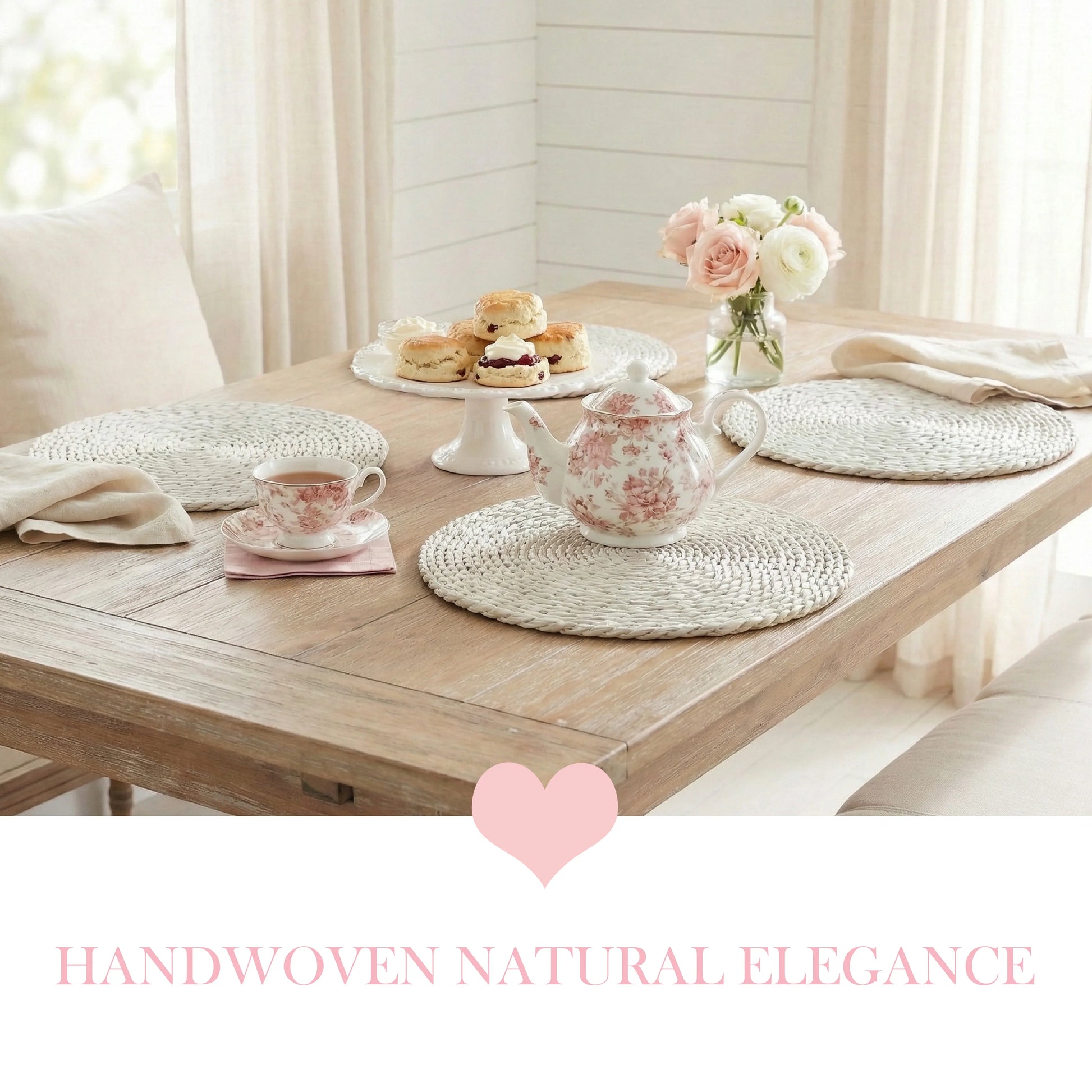 Tea set with floral teapot, scones, and woven placemats on a wood table, featuring a pink heart and text below.