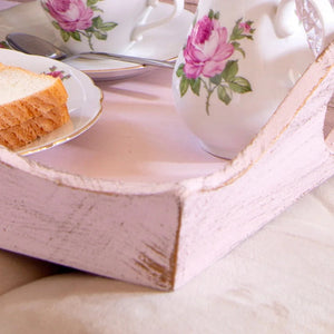 Tea set with floral design on a wooden tray