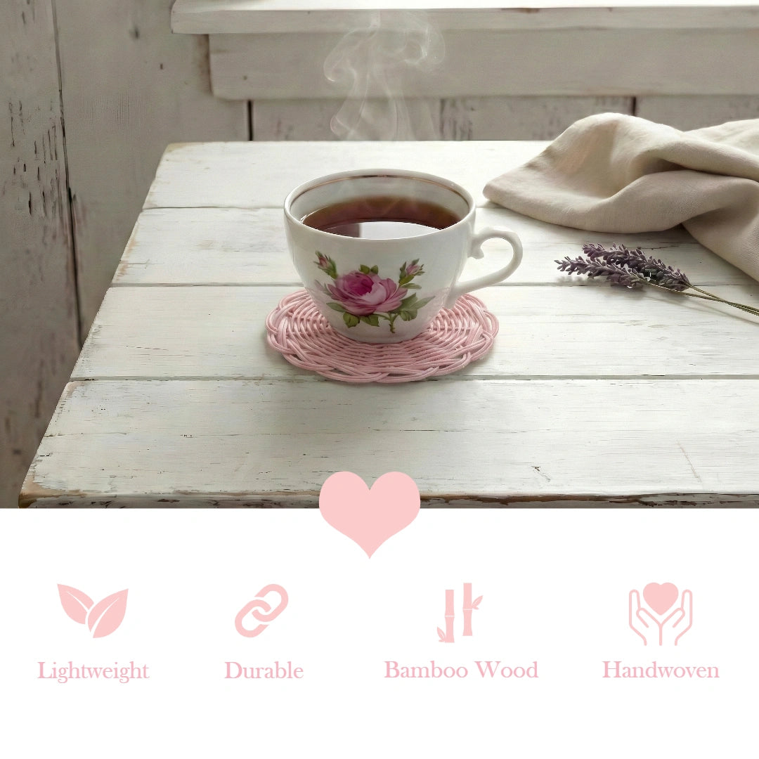 Teacup with floral design on a pink woven coaster on a wooden table, with lavender and a heart symbol.