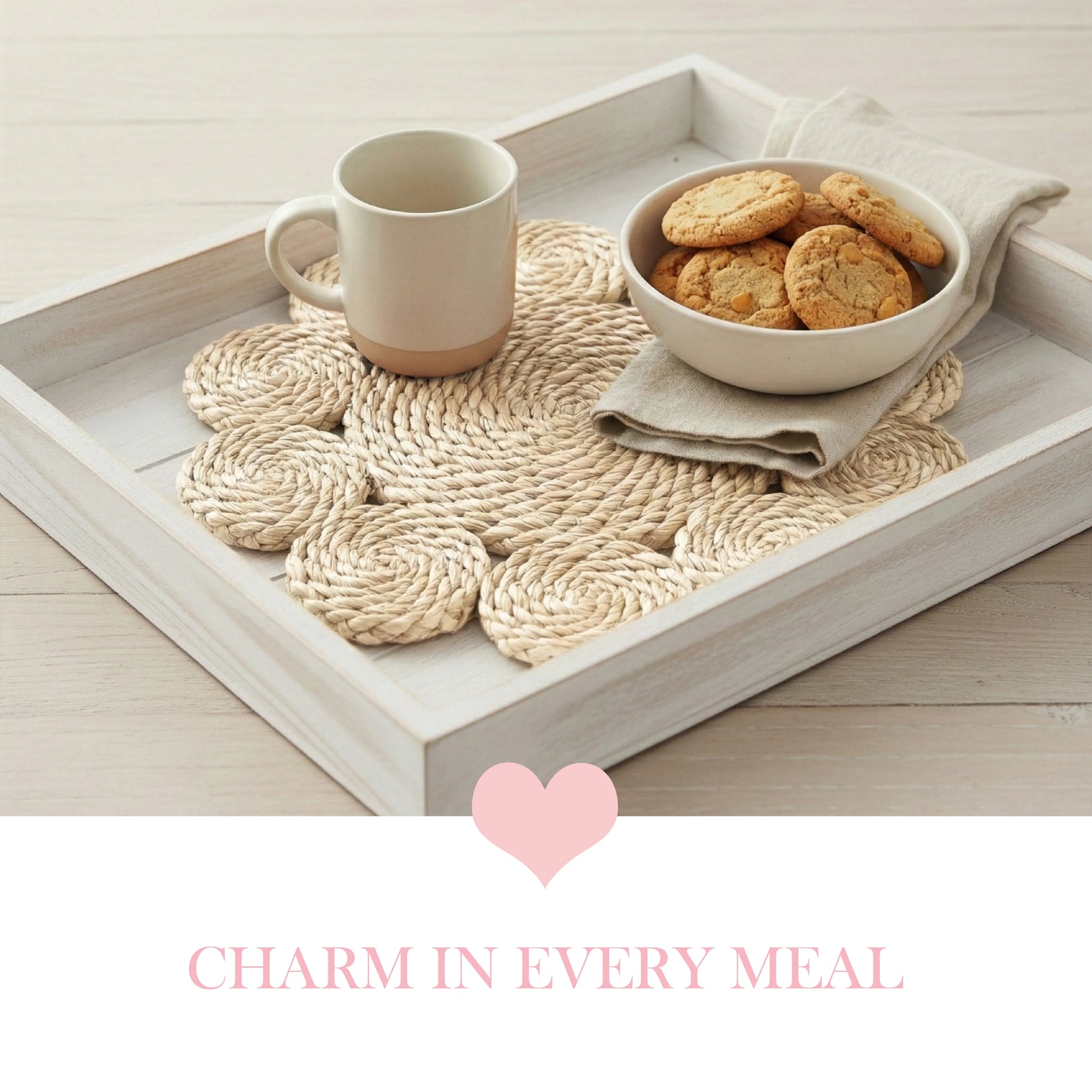 Flower-shaped woven placemat used as a tray liner for a white mug and a bowl of cookies on a distressed light wood tray.