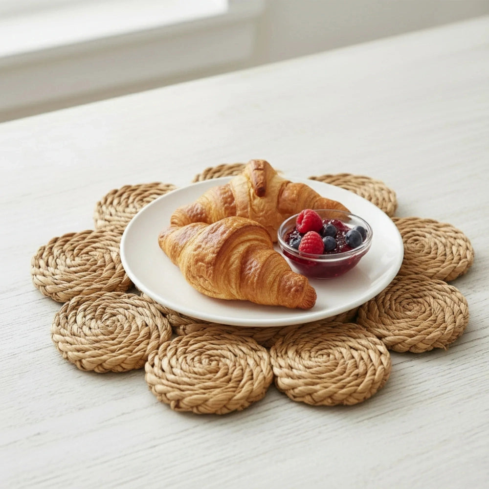 Halfa Flower-Shaped Placemat used in table setting with croissants and berries on woven natural texture base