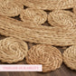 Close-up of braided jute rope with 'Timeless Durability' text on a wooden surface