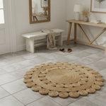Round woven rug on a tiled floor with wooden furniture and decor.