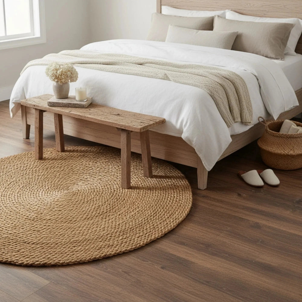 Halfa Round rug placed in bedroom with wooden bench, bed, and white bedding for home decor styling
