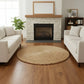 Living room with white sofas, a fireplace, and a round woven rug.