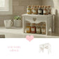 Heart Cut-Out Countertop Table displaying spice jars on wooden stool with tiled wall background