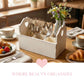 Heart Cut-Out Flatware Holder holding silverware on a breakfast table with croissants and coffee