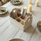 Heart Cut-Out Flatware Holder displayed with cutlery on a rustic wooden table beside candles