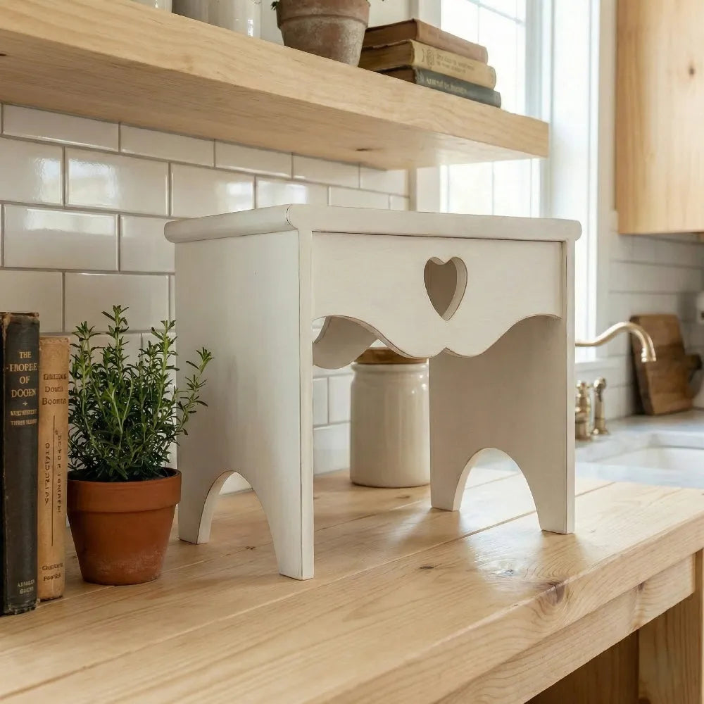 Heart Cut-Out Countertop Table in white wood displaying books and plants