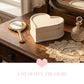 Heart-shaped box, hand mirror, and perfume bottle on a wooden surface with 'A Heartful Treasure' text.