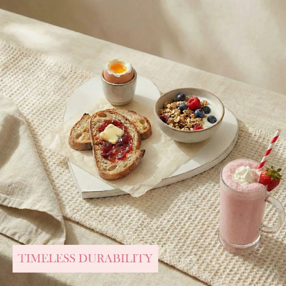 Heart-Shaped Serving Board used in breakfast setting with toast egg granola bowl and pink milkshake on textured surface