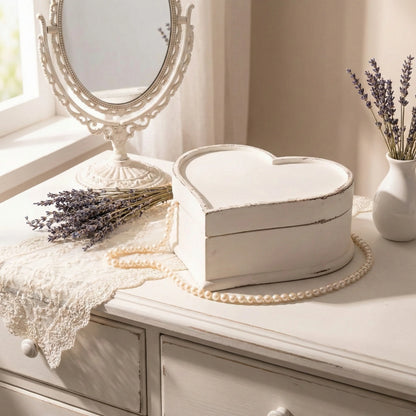 Heart-shaped wooden box on a dresser with lavender and a mirror in the background