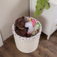 Large Cottage Wicker Hamper beside a white cabinet storing stuffed toys on a wooden floor