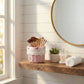 Mini Tube Wicker Basket used as bathroom storage holding makeup brushes on shelf beside mirror and window