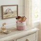 Mini Tube Wicker Basket holding makeup brushes displayed on wooden dresser with decorative farmhouse wall painting