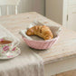 Mini Wicker Basket holding croissant on wooden table with floral teacup for home decor styling