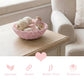 Mini Wicker Basket pink woven with yarn and wooden items on a wooden table with beige sofa background