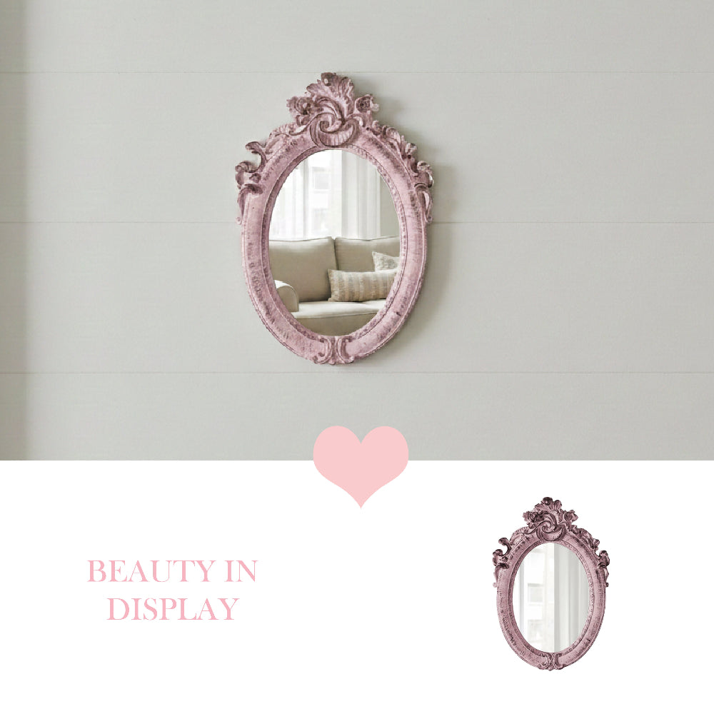 Ornate pink oval mirror on a white shiplap wall reflecting a couch, with a heart icon and Beauty in Display text.