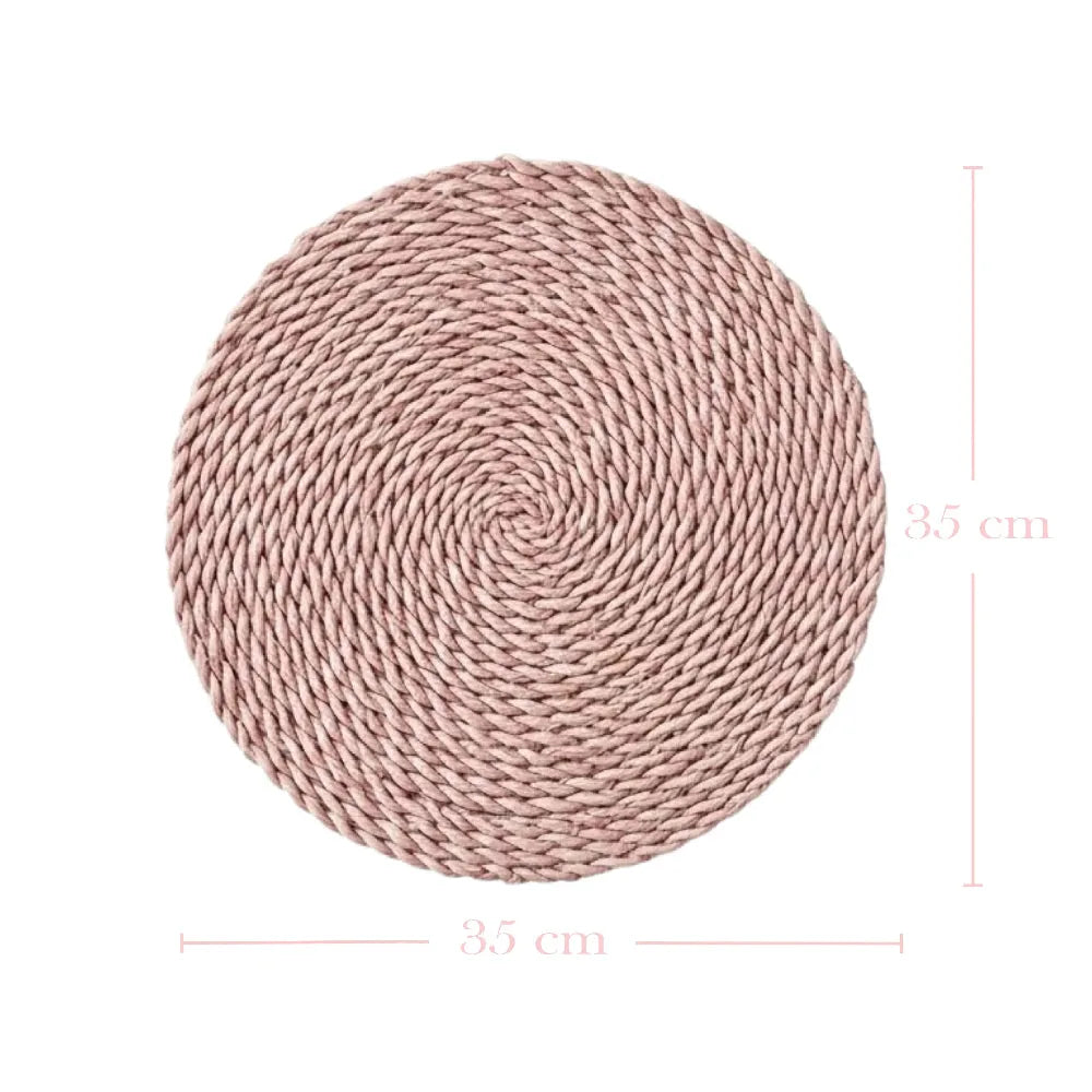 Round pink woven mat with dimensions on a white background