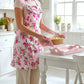 Person wearing a floral apron in a kitchen setting