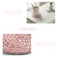 Collage showing a pink round coaster with a mug on a white wood table and a close-up of the woven pink grass texture.