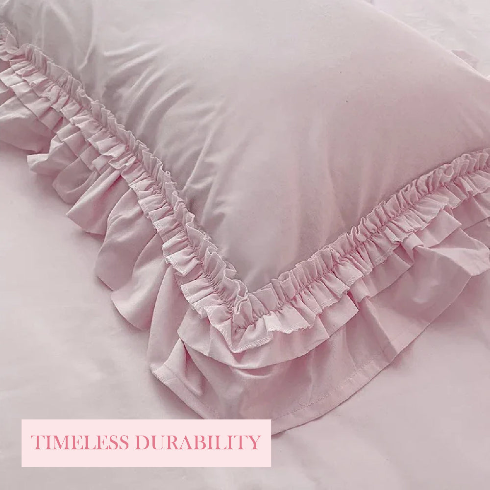Close-up of a pink ruffled pillowcase with "Timeless Durability" text on a pink banner.