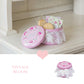 Pink vintage-style cookie tin with lace detailing on a white surface, labeled 'Vintage Bloom'.
