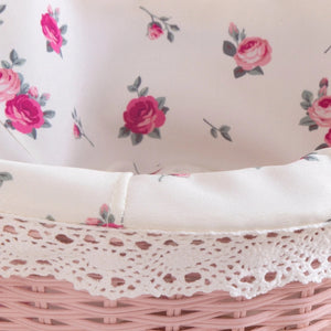 Pink wicker basket with floral linen and lace trim