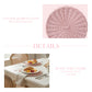 A product graphic showing a pink wicker placemat and a lifestyle scene of a set table with croissants and tea.