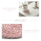 Pink woven coaster with a cup of coffee on a wooden table, with text describing the product.