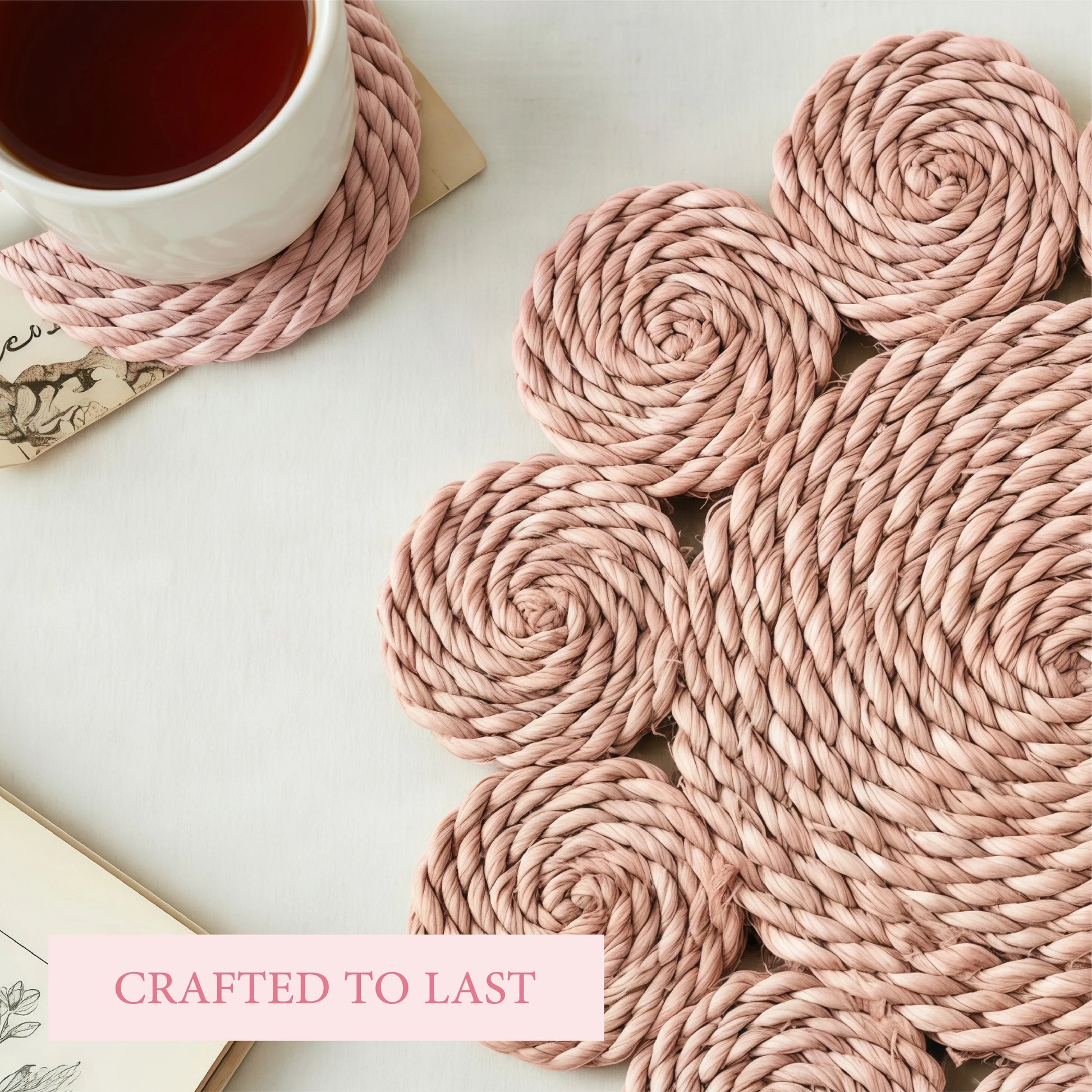 Close-up of a pink woven flower-shaped placemat and matching coaster with a white mug of tea on a white surface.