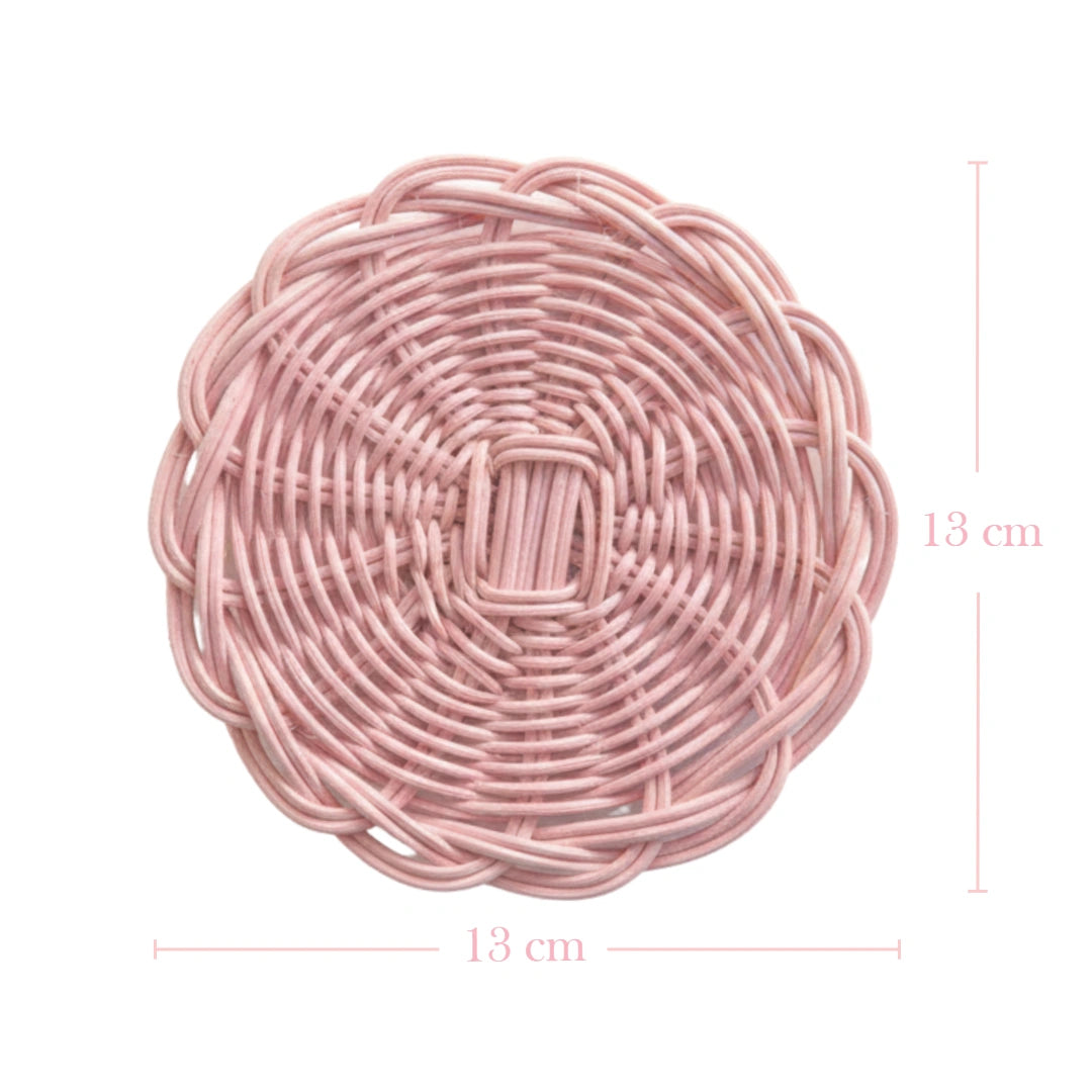 Pink woven round mat with dimensions on a white background