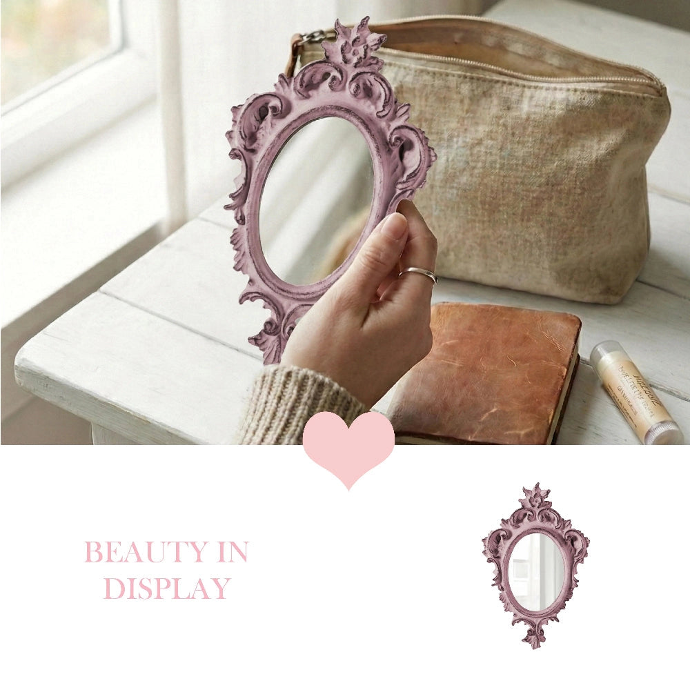 Pretty Shabby Wall Mirror – Oval Chic held in hand, small pink decorative mirror with beige pouch and notebook background