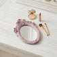 Pretty Shabby Wall Mirror – Oval Fleur displayed with makeup accessories on a light wooden surface