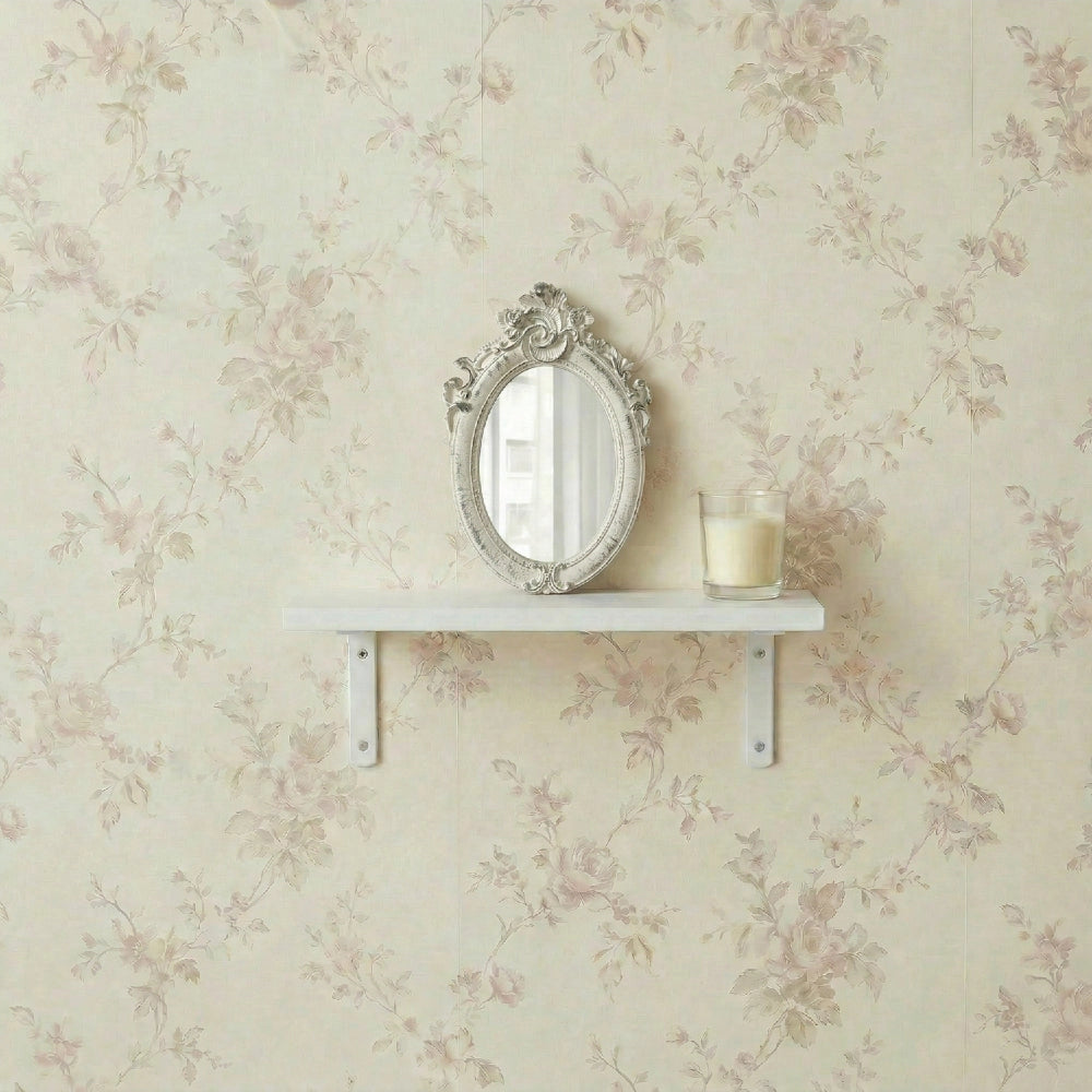 Pretty Shabby Wall Mirror – Oval Fleur displayed on a shelf against floral wallpaper