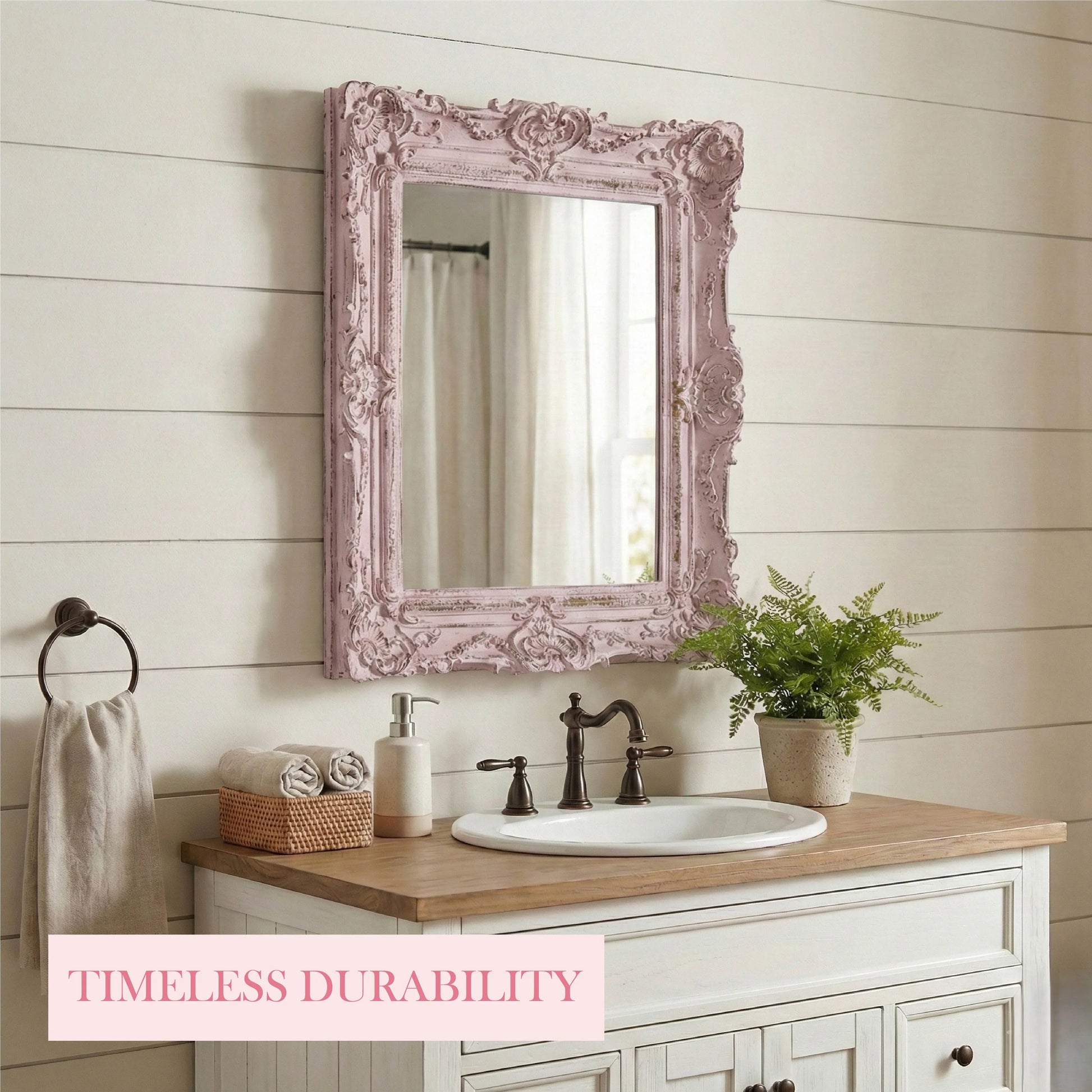 Bathroom vanity with ornate pink mirror, sink, and decor elements.
