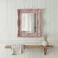 Pretty Shabby Wall Mirror Rectangular Vintage placed on pink paneled wall above wooden shelf with plant decor