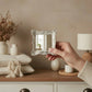 Pretty Shabby Wall Mirror Square Chic held in hand with blurred indoor background